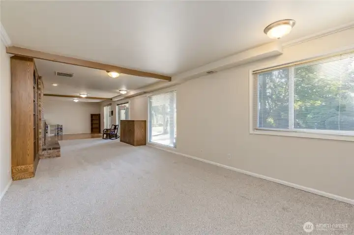 Family room in the finished basement with dining area and 2nd kitchen beyond, 3/4 bath behind - possible ADU?