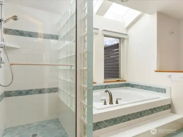 Primary bath with shower and soaking tub.