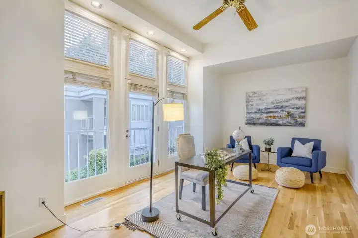 Light & bright with ceiling fans and big windows.