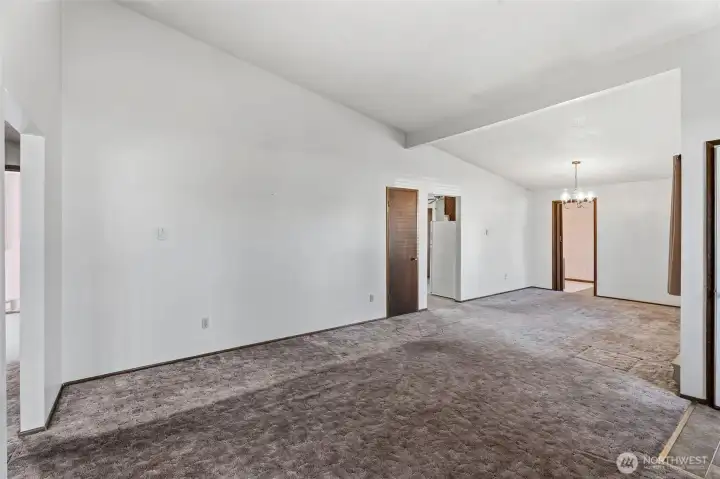 Living room open to dining, vaulted ceiling