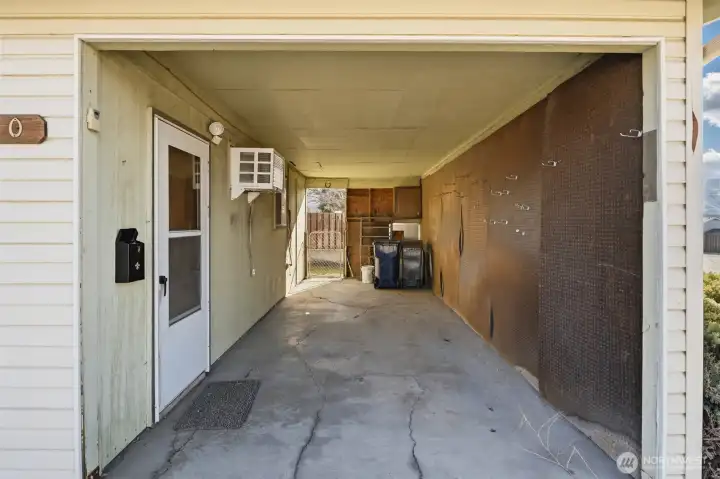carport area with man door to salon conversion