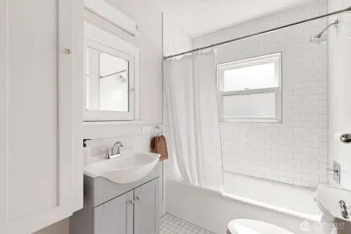 Full bathroom on the main floor has been classically updated.