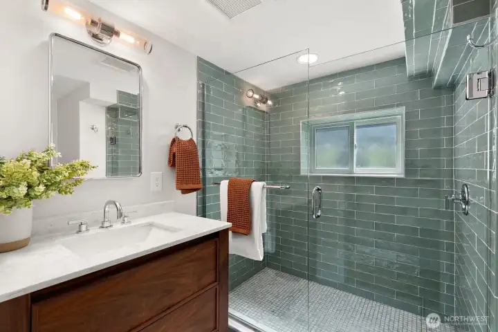 Stunning bathroom on the lower level has a walk-in shower and heated floors.
