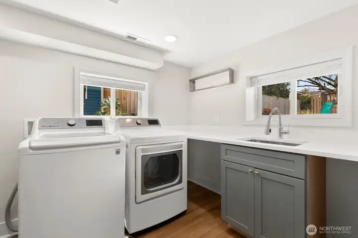 The laundry room has a newer washer and dryer - and TONS of storage!