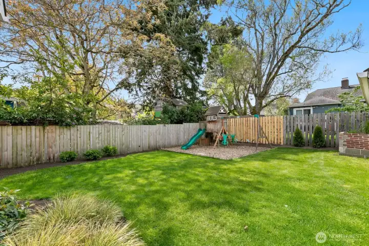 The lush backyard was fully renovated just a few years ago. It's the perfect play space or entertainment for BBQs! Just in time for summer!