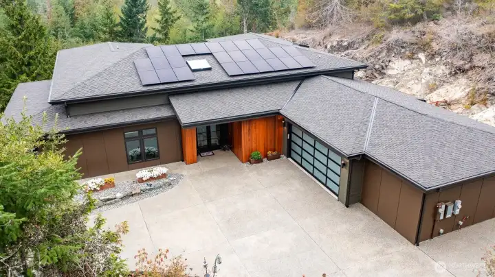 Nestled on lot to create privacy, take in natural beauty and create outdoor living spaces that area easy to maintain and enjoy.  Two car garage with extended area which could be a possible third bay.