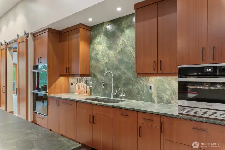 Touchless faucet, instant hot and cold filtered water, under counter lighting, Miele speed oven and warming drawer.  Nothing left to desire.