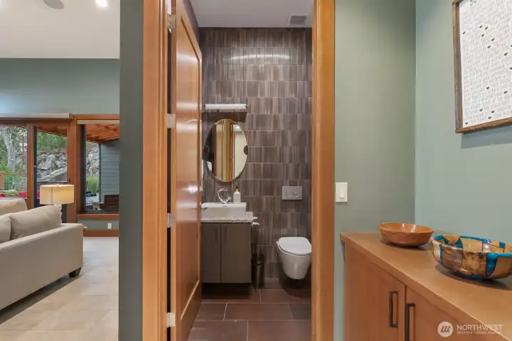 Powder bath is off of living room/office area. Beautiful custom tile wall.