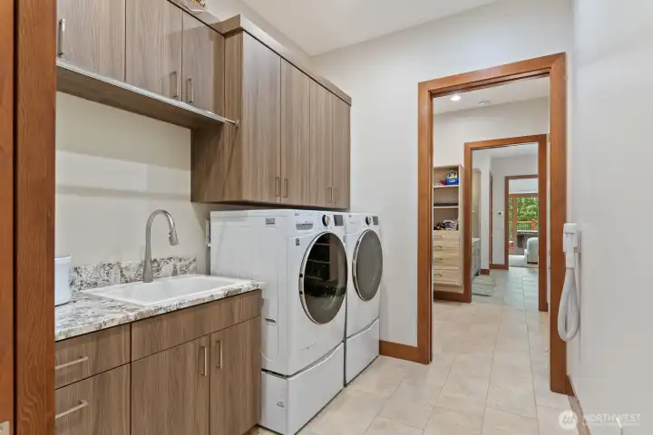 Well sized laundry with additional storage.