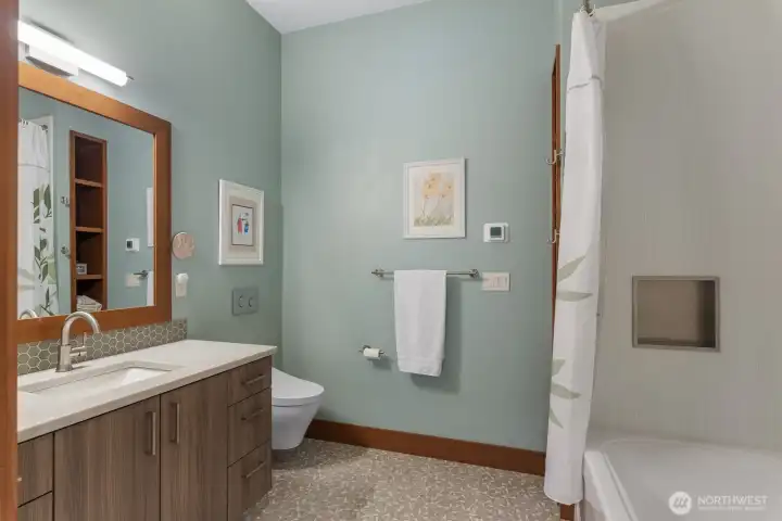 Full bath with custom tile set between secondary bedrooms.  This wing is perfect for everyday living or guests.