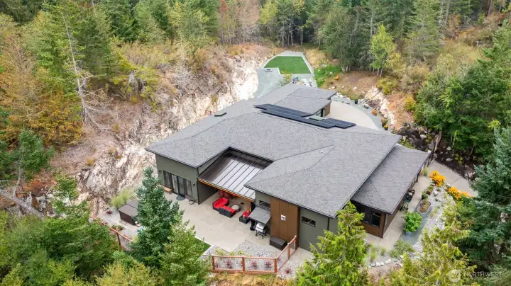 Great view to see how this homes beautiful setting.  Home is solar and has large buried propane tank.  Auto water irrigation system, motion lights and two outside cameras as well.