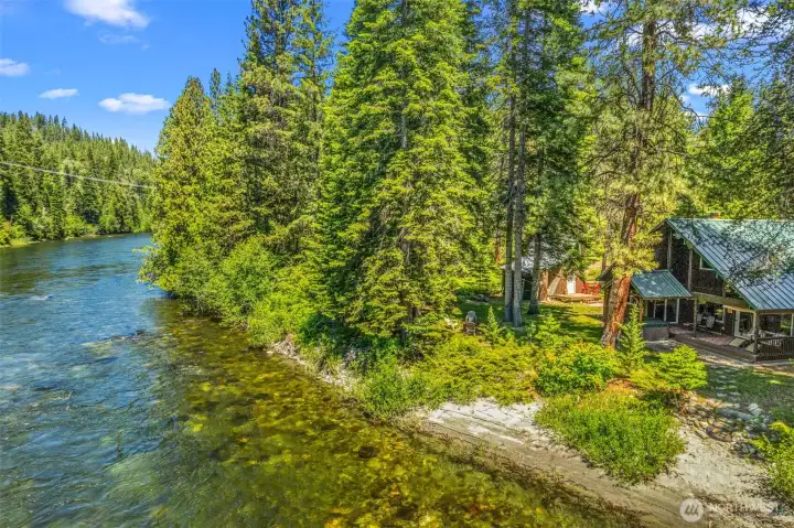 Rare Wenatchee River frontage with a sandy shoreline, guest cabin, detached shop, and private hot tub retreat. Nestled among towering evergreens, this waterfront property offers the perfect blend of mountain charm, recreation, Rare Wenatchee River frontage with a sandy shoreline, guest cabin, detached shop, and private hot tub retreat. Nestled among towering evergreens, this waterfront property offers the perfect blend of mountain charm, recreation,