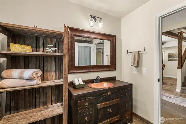 This custom bathroom features a handcrafted wood vanity, hammered copper sink, and rich wood accents throughout This custom bathroom features a handcrafted wood vanity, hammered copper sink, and rich wood accents throughout