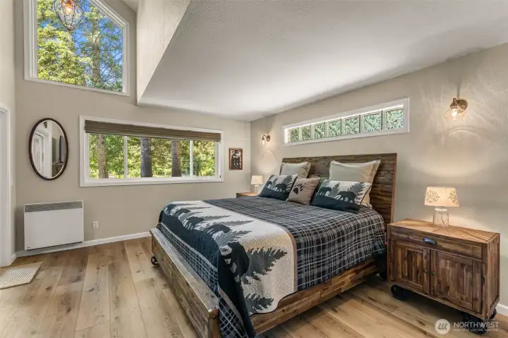 The spacious bedroom offers a comfortable escape and easy access to the home's outdoor living spaces and riverfront setting. The spacious bedroom offers a comfortable escape and easy access to the home's outdoor living spaces and riverfront setting.