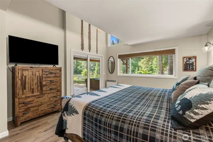 The spacious bedroom offers a comfortable escape and easy access to the home's outdoor living spaces and riverfront setting. The spacious bedroom offers a comfortable escape and easy access to the home's outdoor living spaces and riverfront setting.