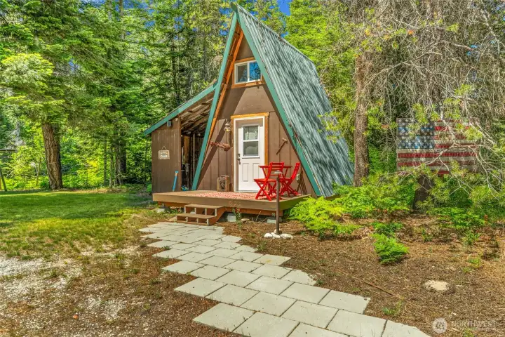 Charming dry cabin, detached shop, and park-like grounds connected by pathways and surrounded by mature evergreens. A private setting with ample space for outdoor recreation and entertaining. Charming dry cabin, detached shop, and park-like grounds connected by pathways and surrounded by mature evergreens. A private setting with ample space for outdoor recreation and entertaining.