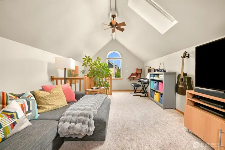 Bright and inviting loft-style living area features soaring ceilings, skylights, and ample room for work, relaxation, or hobbies. Bright and inviting loft-style living area features soaring ceilings, skylights, and ample room for work, relaxation, or hobbies.