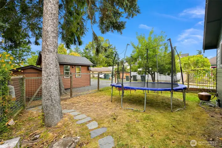 Fully fenced side yard offers room to play, garden, or relax beneath mature trees, creating a peaceful outdoor setting with plenty of usable space. Fully fenced side yard offers room to play, garden, or relax beneath mature trees, creating a peaceful outdoor setting with plenty of usable space.