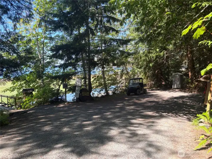 Small parking lot at the community beach with bacis facilities. You can access the beach and the trail system from parking lot.