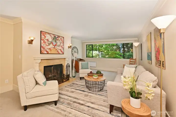 Large living room with a wood-burning fireplace, new carpet and paint.