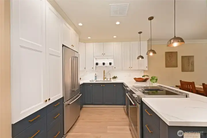 The kitchen has ample cabinet and counter space. That's a large sink in the background.