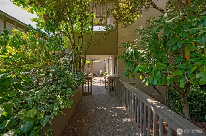 Lush gardens line the entry to your private courtyard entry.
