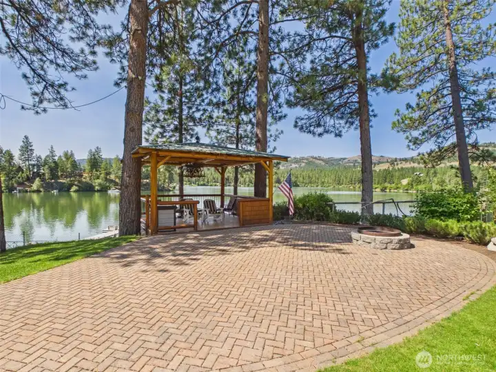 Spend your evenings gathered around the custom herringbone paver patio and firepit as the sun sets over the water.