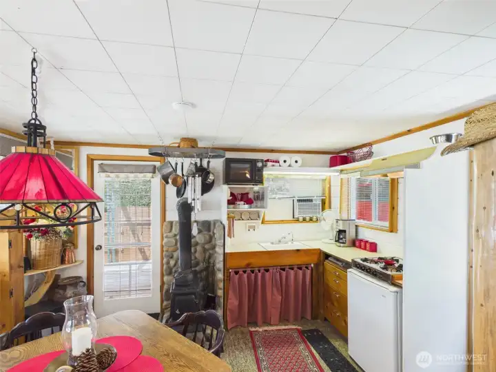 The cabin featuring its own kitchenette, bathroom with shower, custom log bunk beds and comfortable living space.