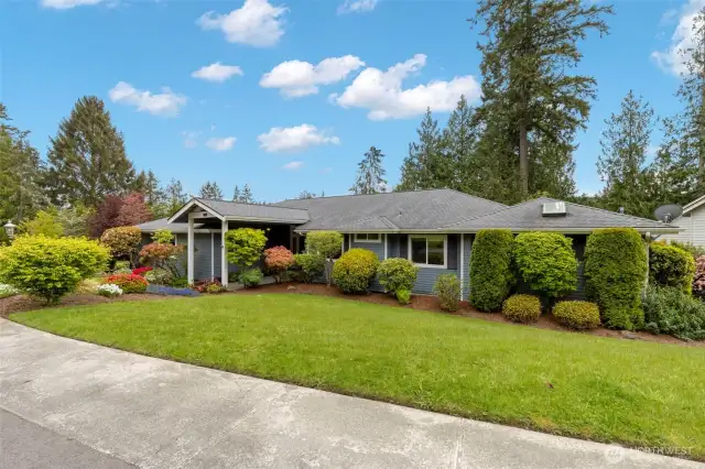 Covered entryway and mature landscaping.