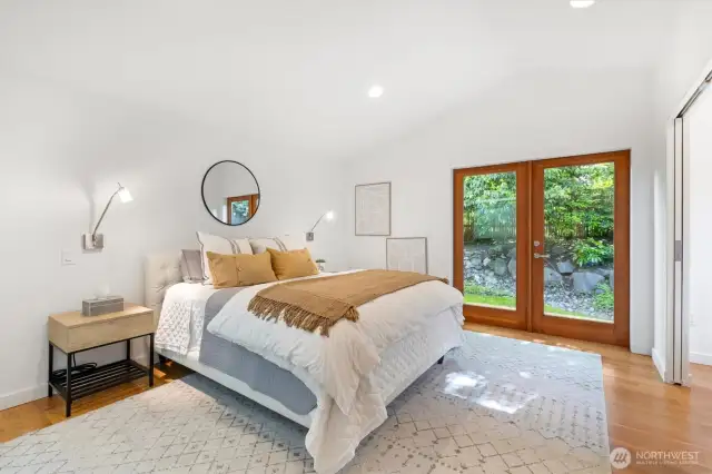 Lavish primary suite with french doors that open to deck, huge walk in closet with organizer, separate office niche an spa like bath