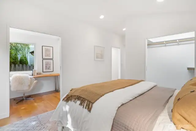 Lavish primary suite with french doors that open to deck, huge walk in closet with organizer, separate office niche an spa like bath