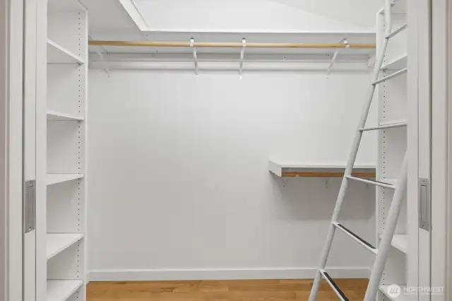 Lavish primary suite with french doors that open to deck, huge walk in closet with organizer, separate office niche an spa like bath. This is the walk in closet with built in organizer