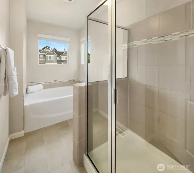 Luxurious primary bath with spacious shower and relaxing tub