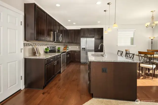 Chef-inspired kitchen featuring hardwood floors and sleek stainless steel appliances