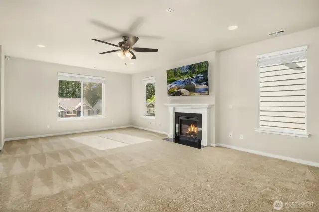 Spacious living room anchored by a cozy gas fireplace