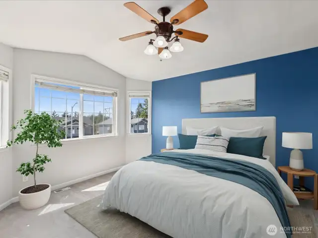 Vaulted ceilings, ceiling fan, large windows help this suite live large