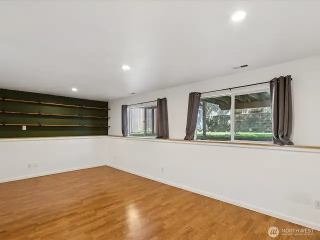 View of built in shelves on far wall & the overall scale of family room