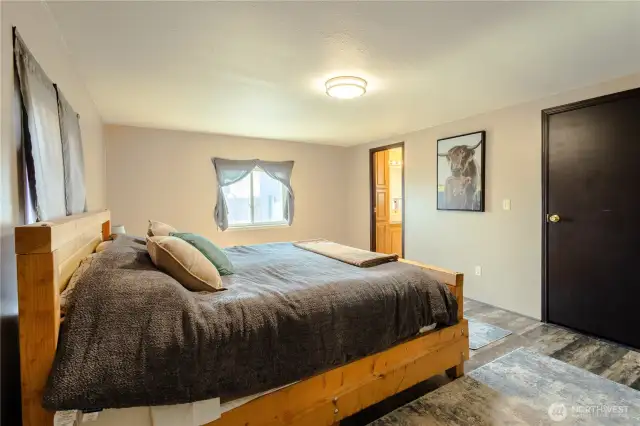 Primary Bedroom with closet to the right and bathroom to the left