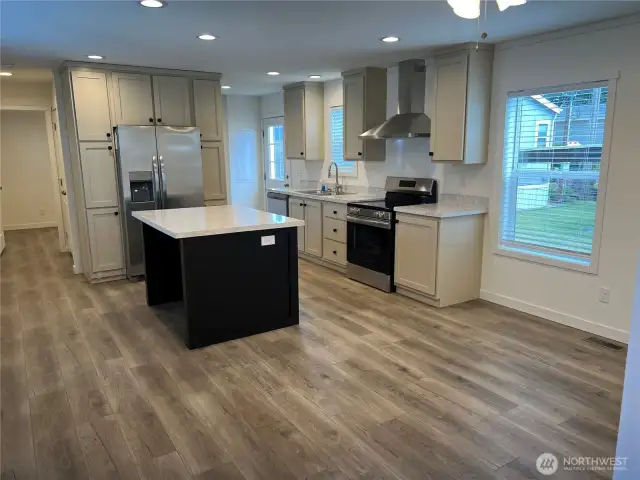 Kitchen from the living room with an island and SS appliances.