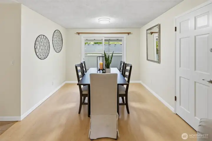 Spacious dining room with a slider that opens to the large covered deck.