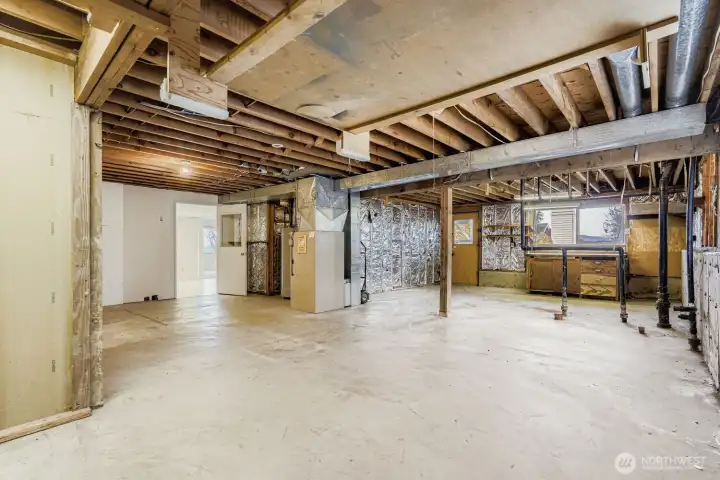 Massive unfinished area in lower level.  Plumbing is already for another bathroom.  Could add 2 or 3 more bedrooms.  Separate entrance leads to back yard.
