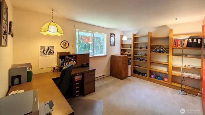 This bedroom currently serves as an office. The shelves are custom made and will remain with the home.