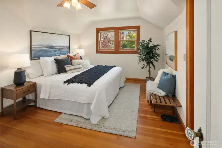 There are two closets in the primary bedroom and north and east facing windows trimmed in clear fir to match the floors.
