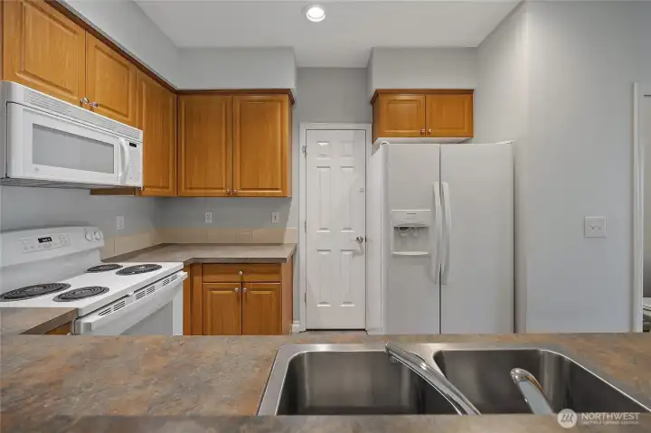 The kitchen features a charming pass-through window overlooking the dining area, bridging the two spaces perfectly and ensuring you never miss a moment when entertaining guests or keeping an eye on the family. The kitchen features a charming pass-through window overlooking the dining area, bridging the two spaces perfectly and ensuring you never miss a moment when entertaining guests or keeping an eye on the family.