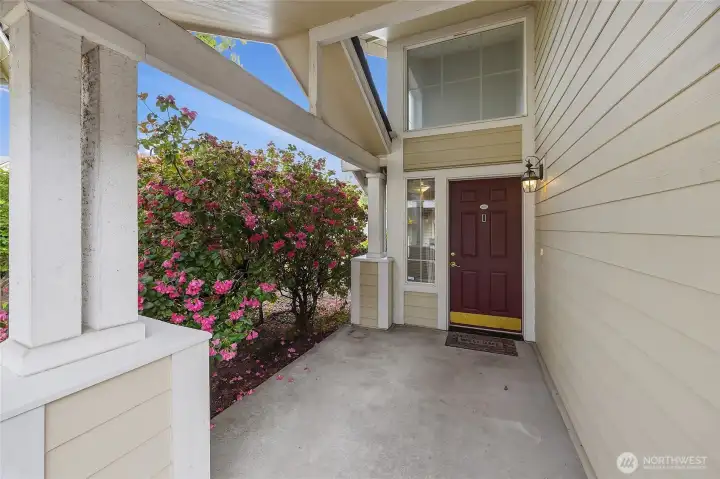 A welcoming entryway framed by beautiful flowers — because first impressions matter and this one delivers. A welcoming entryway framed by beautiful flowers — because first impressions matter and this one delivers.