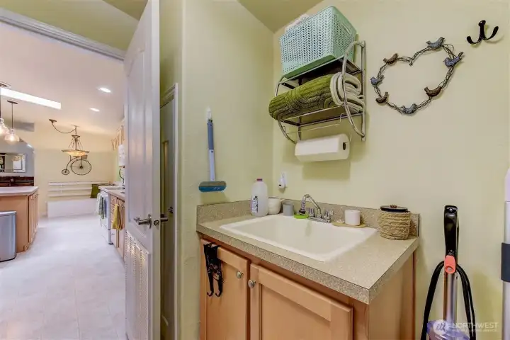 Another view of the laundry/utility room with sink. Another view of the laundry/utility room with sink.