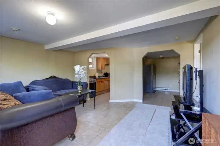 Lower level view of living room and kitchen area