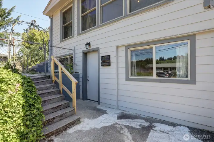Lower-level unit entry with parking in front.