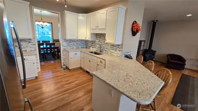 This beautiful kitichen features ample counter space and cupboards (plus walk in pantry). Newly finished hardwood floors, new appliances, new quartz countertops and the list goes on...