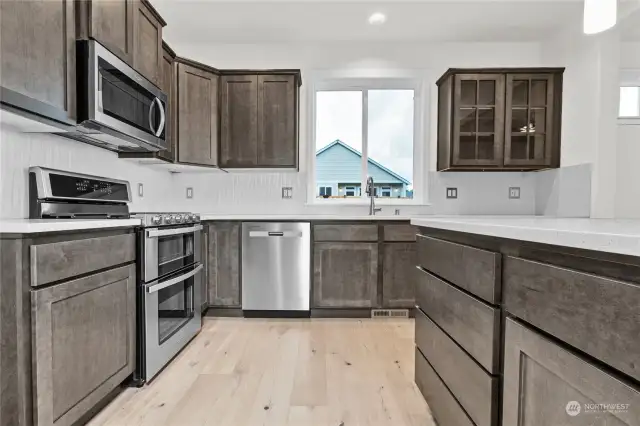 Maple shaker-style cabinetry with full extension guides and soft close drawers. Photo for illustration only of similar home, not actual.